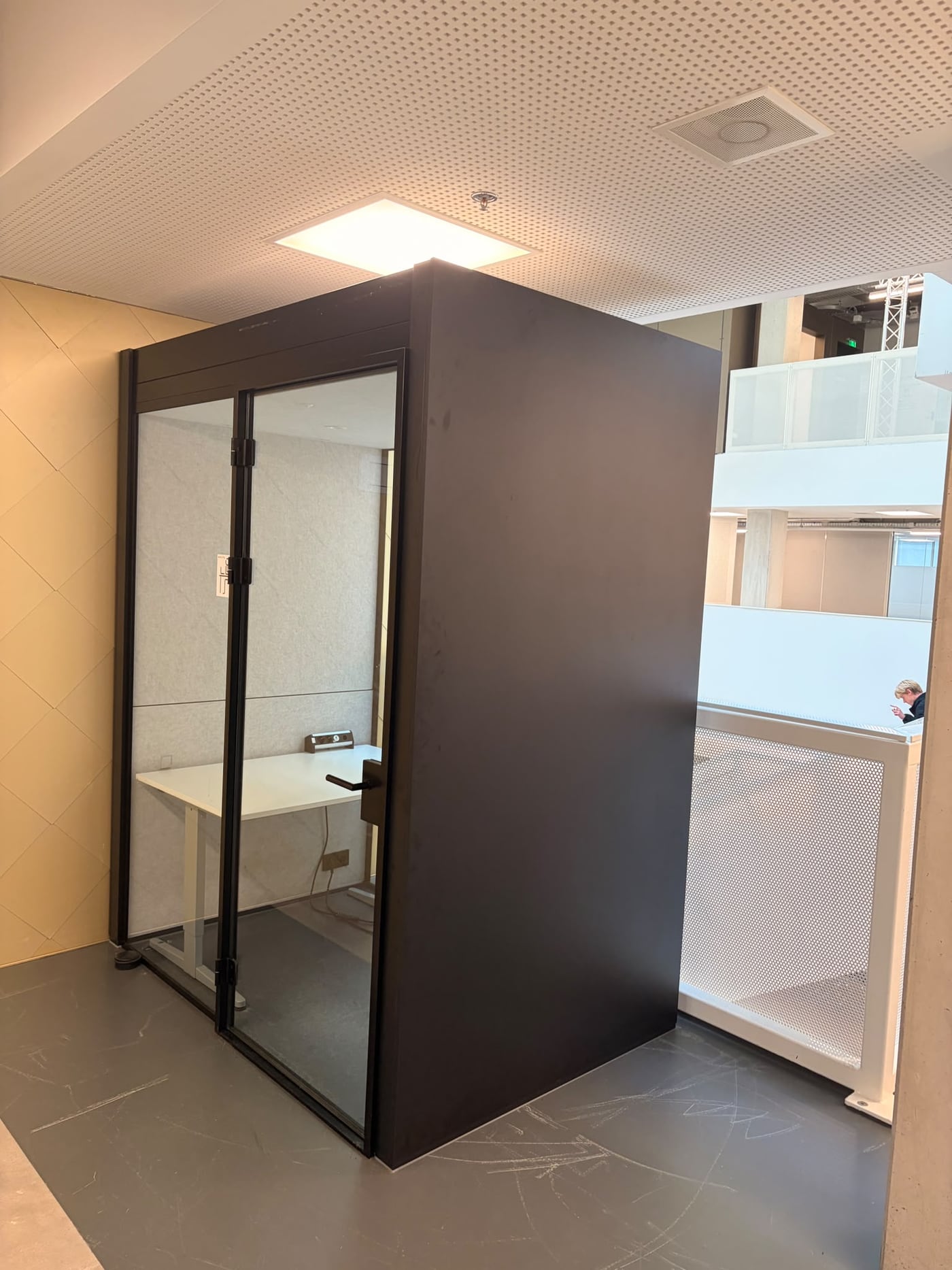 Before: the empty school study booth, black with a glass door and a white desk inside.