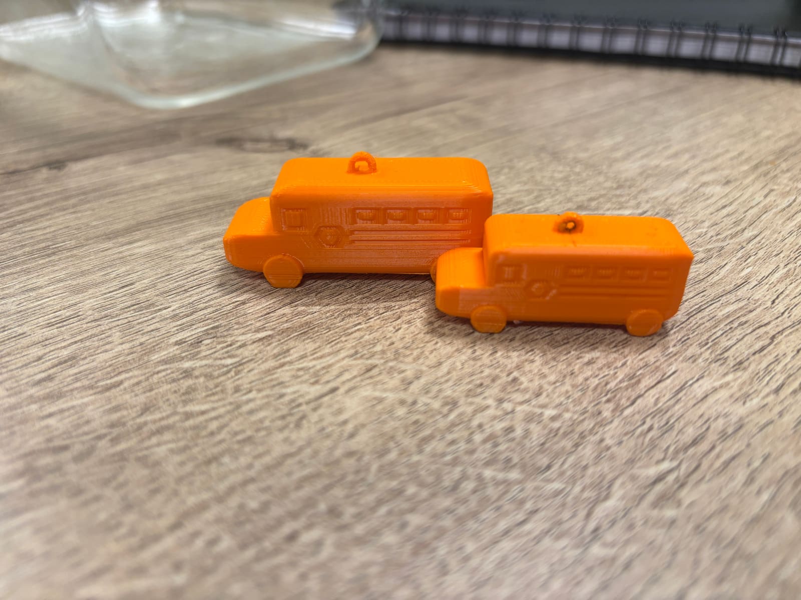 The two orange toy buses we 3D-printed for the test.